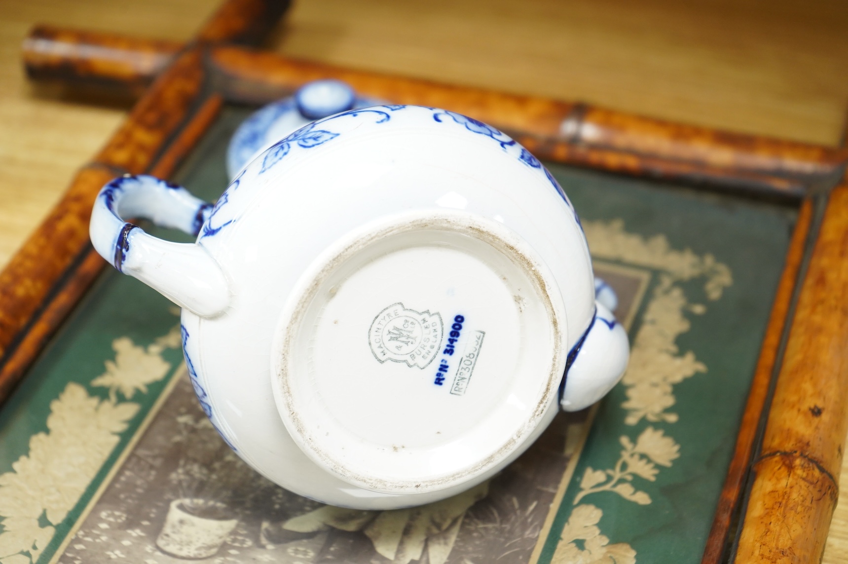 A MacIntyre Burslem blue and white teapot, c.1900, 15cm high and an early 20th century Chinese portrait photograph in a bamboo frame